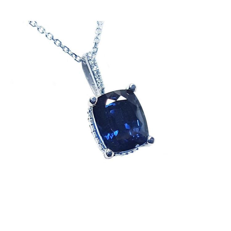 Right side top view of a solitaire blue sapphire necklace cushion cut slider pendant 14k white gold.