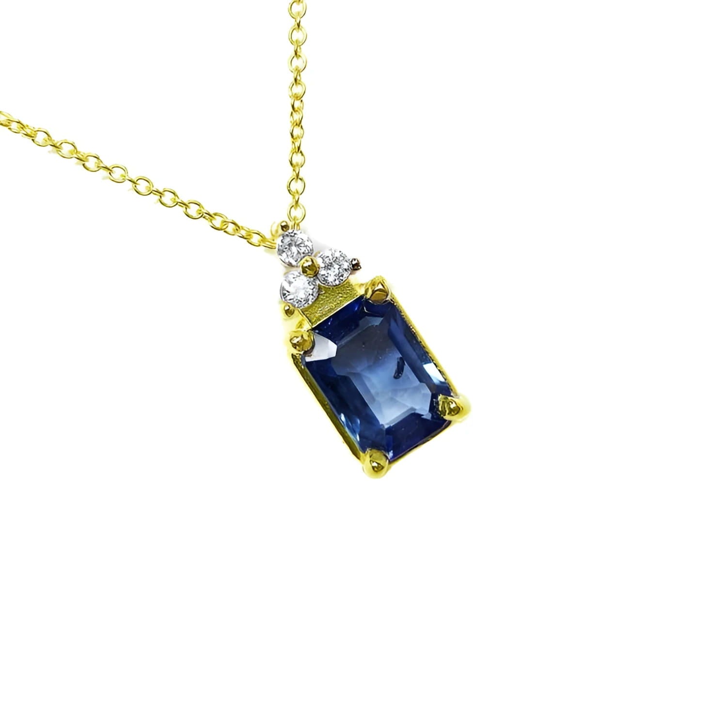 Gold necklace with a natural blue sapphire pendant emerald cut in 14k.