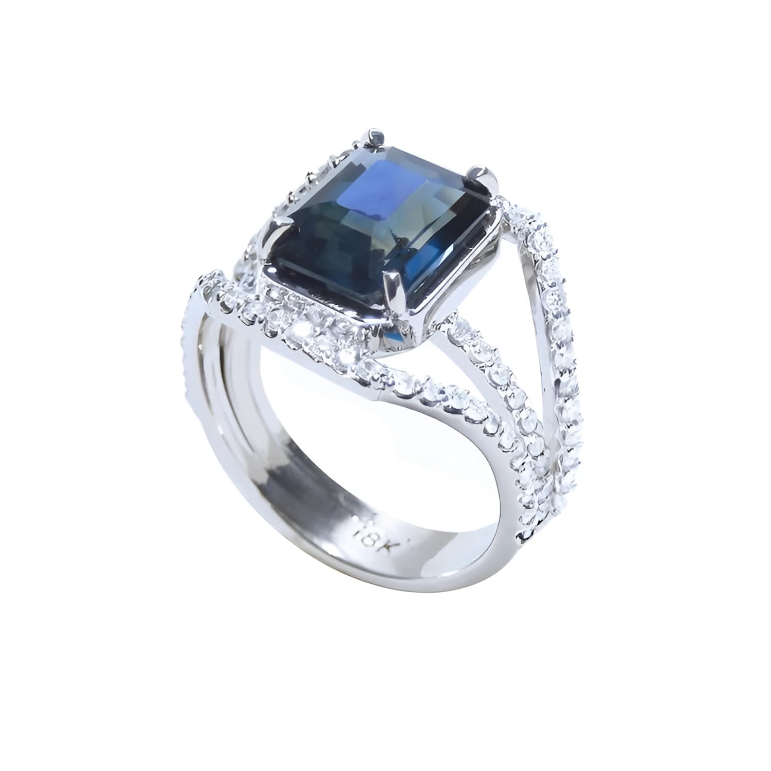 Emerald cut 4.51 ct. blue sapphire ring in 18K gold with a three-row diamond band.