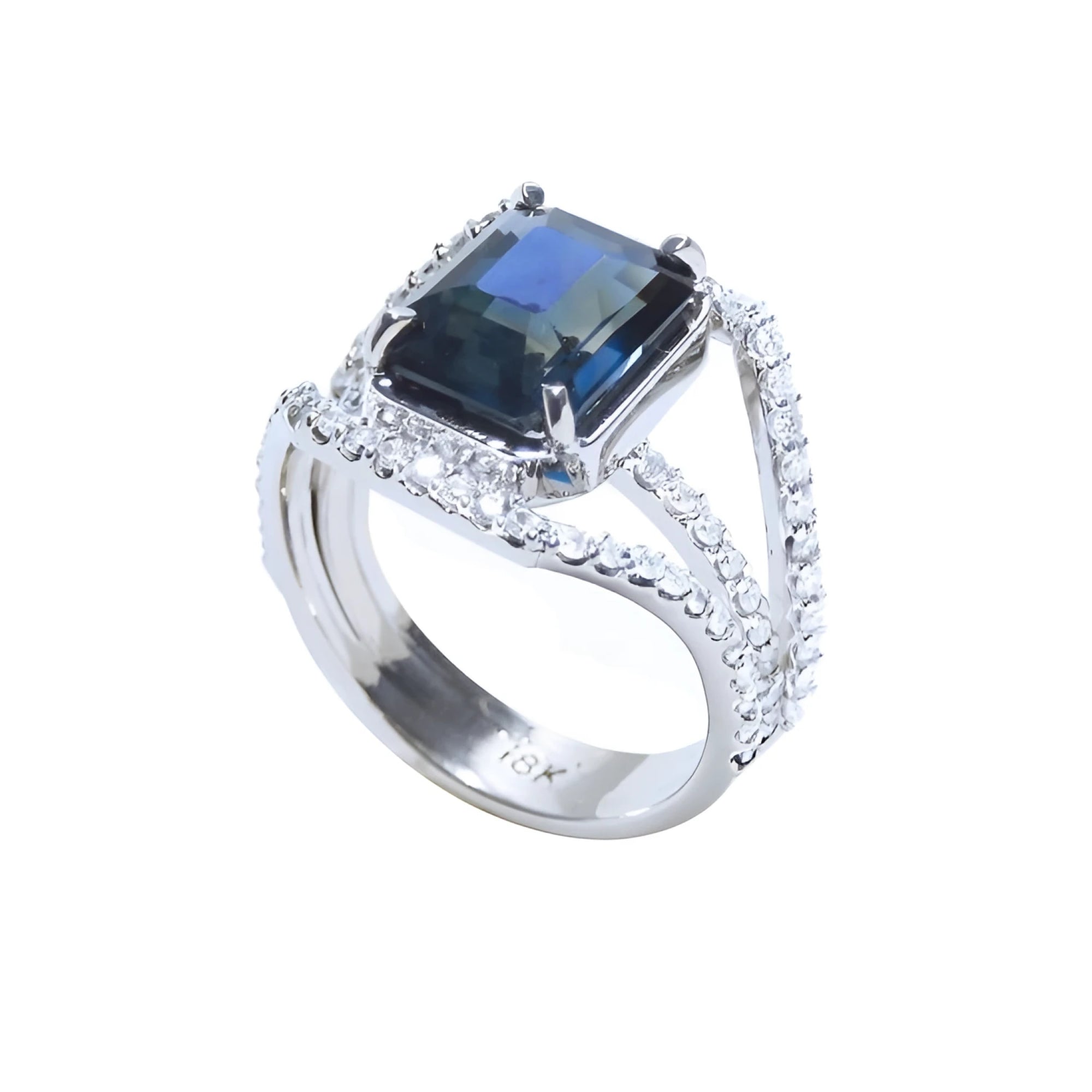 Emerald cut 4.51 ct. blue sapphire ring in 18K gold with a three-row diamond band.