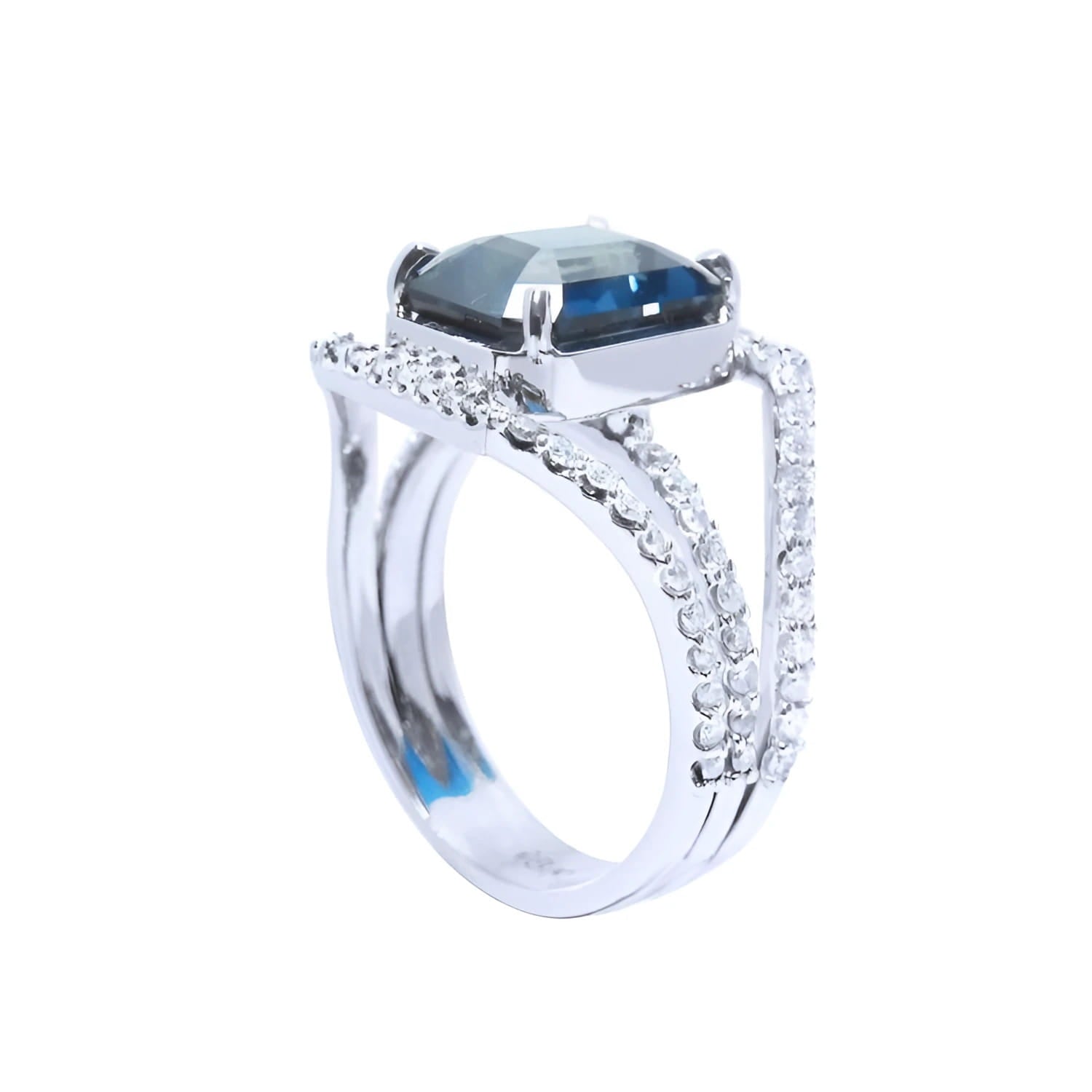 18K white gold ring with a 4.51 ct emerald-cut blue sapphire and a three-row diamond band.