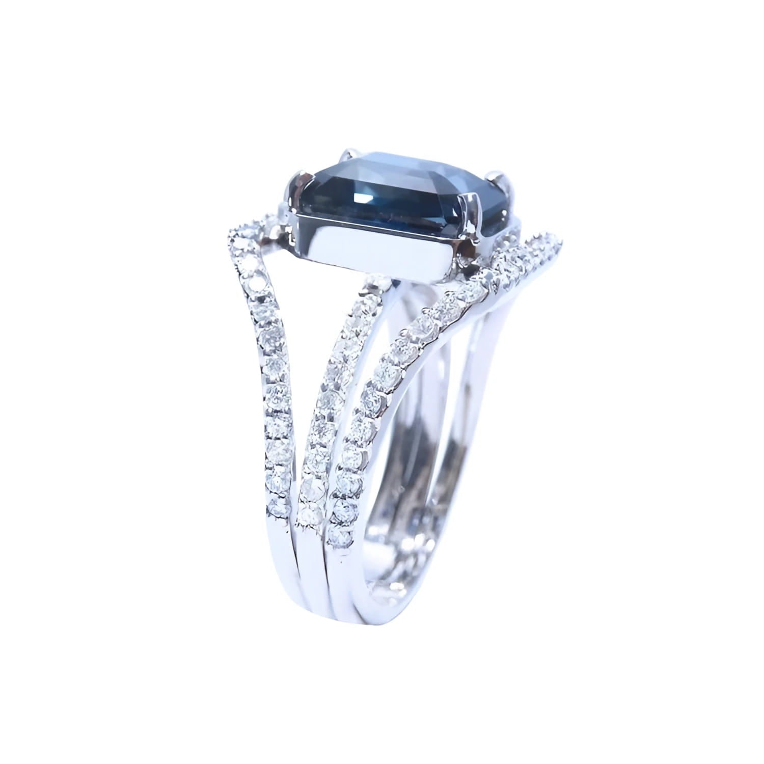 18K white gold ring with a 4.51 ct emerald cut blue sapphire and a three-row diamond band.