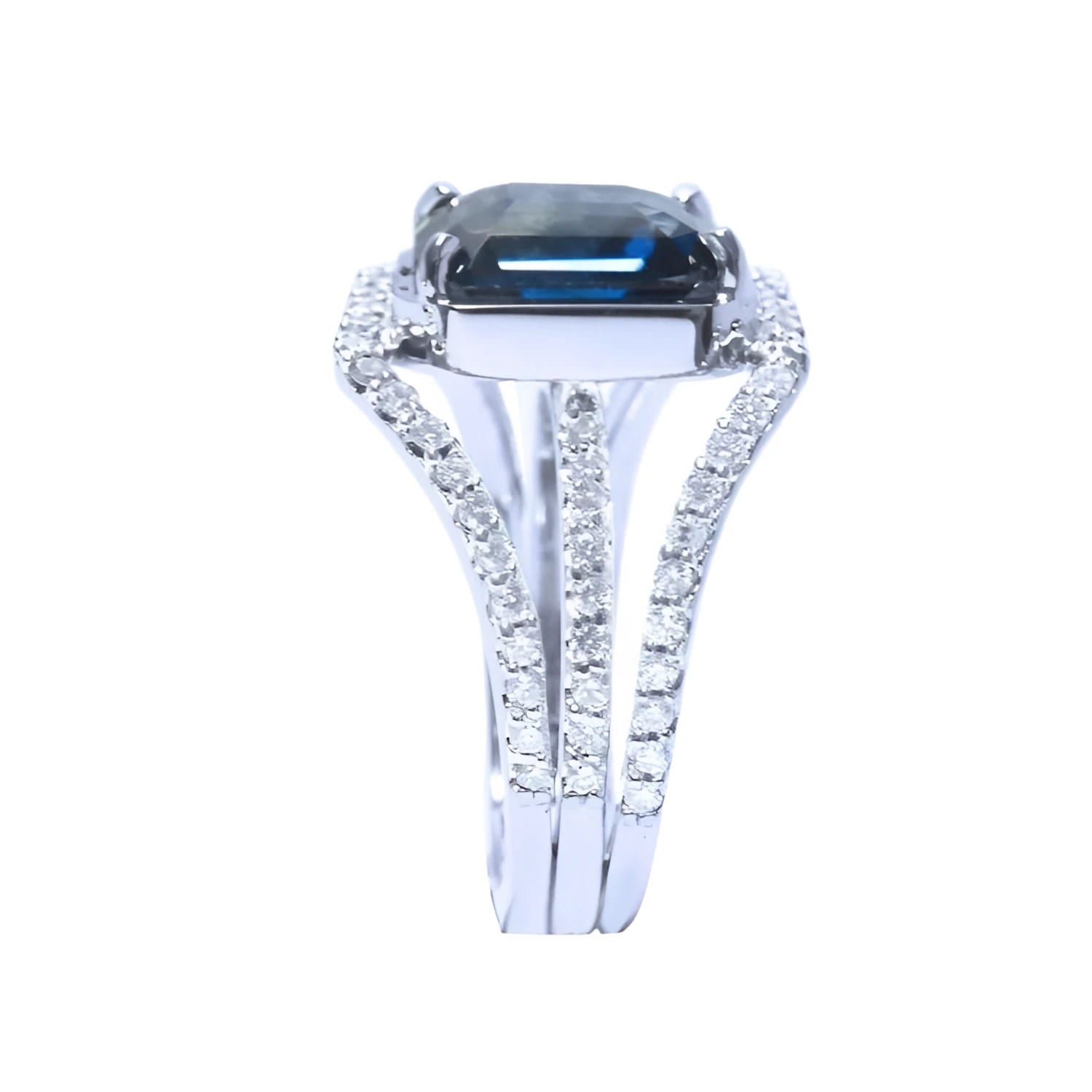 18K white gold ring with a 4.51 ct emerald cut blue sapphire and a three-row diamond band.