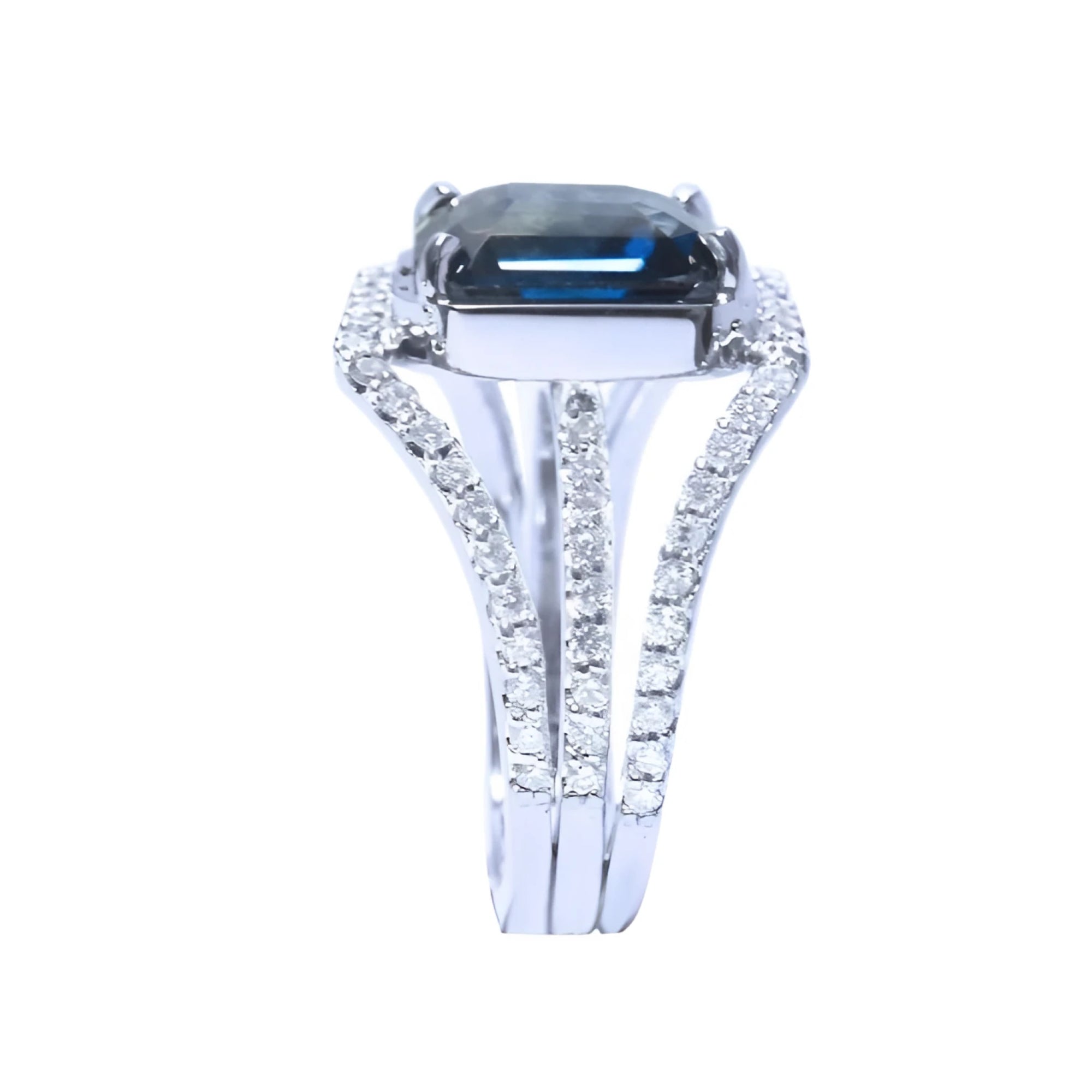 18K white gold ring with a 4.51 ct emerald cut blue sapphire and a three-row diamond band.