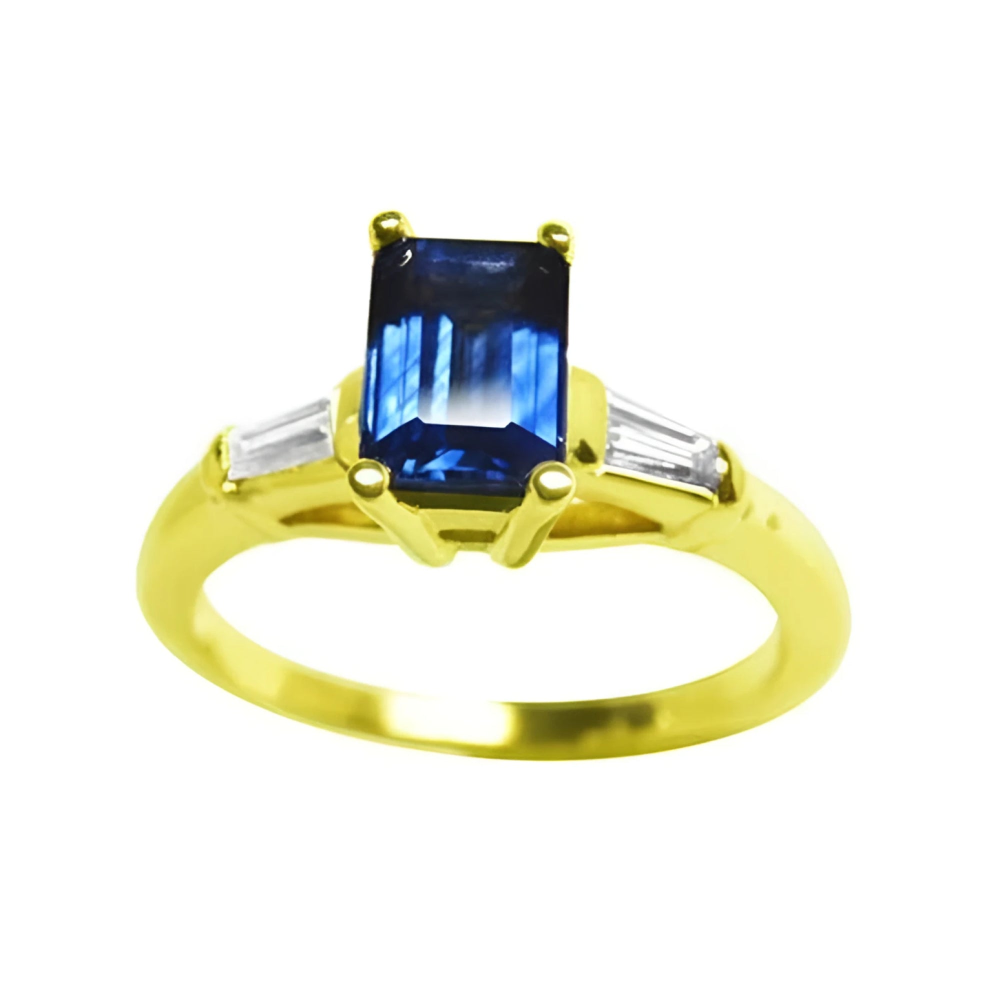 Women's blue sapphires ring rich medium-dark hue, flanked by side tapered baguette diamonds in 14k yellow gold.