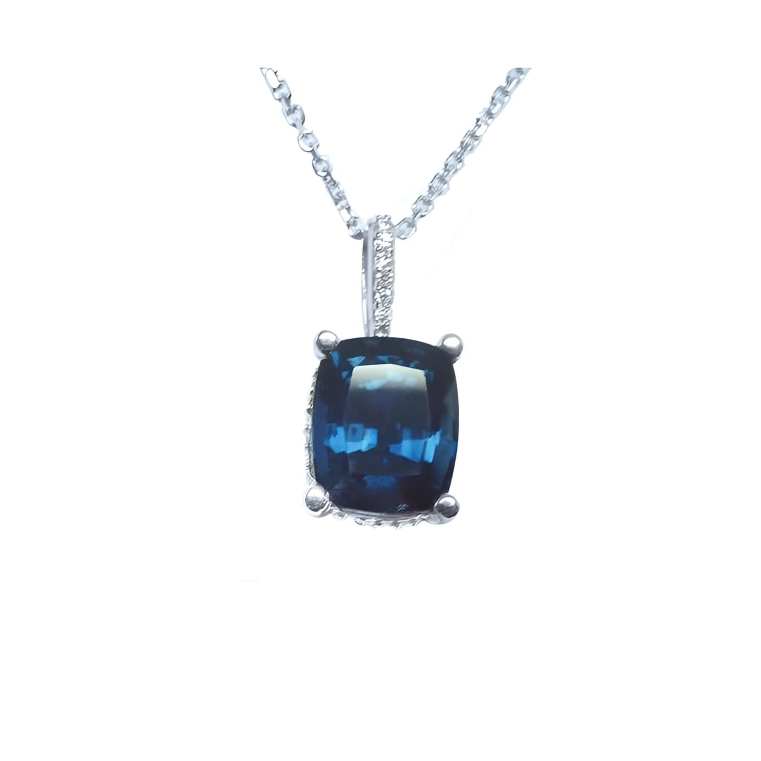 Cushion-cut blue sapphire necklace with a slider pendant, set in a four-prong basket setting of 14k white gold.