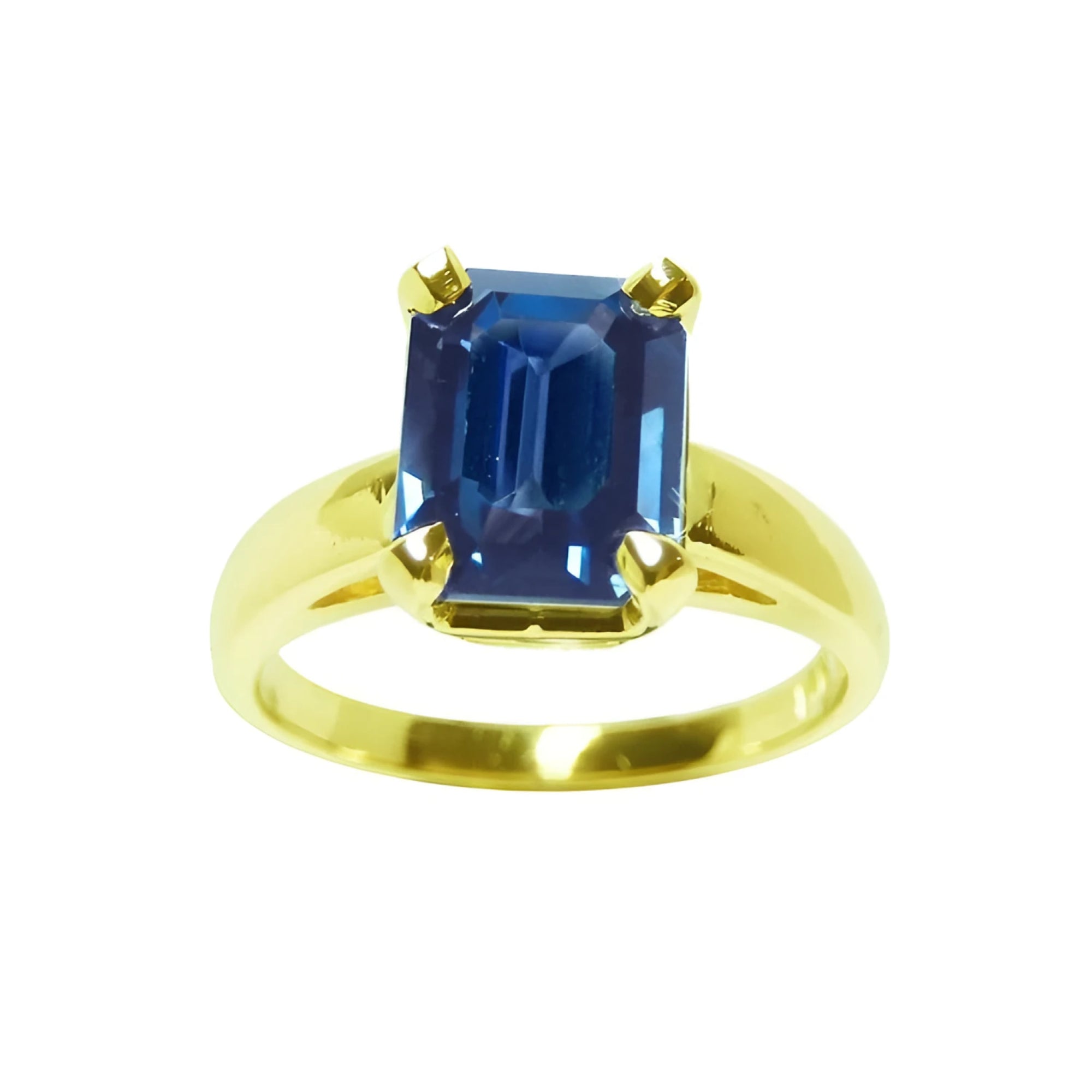 A women’s blue sapphire solitaire ring featuring a deep blue, rectangular emerald-cut sapphire set in 14k yellow gold.