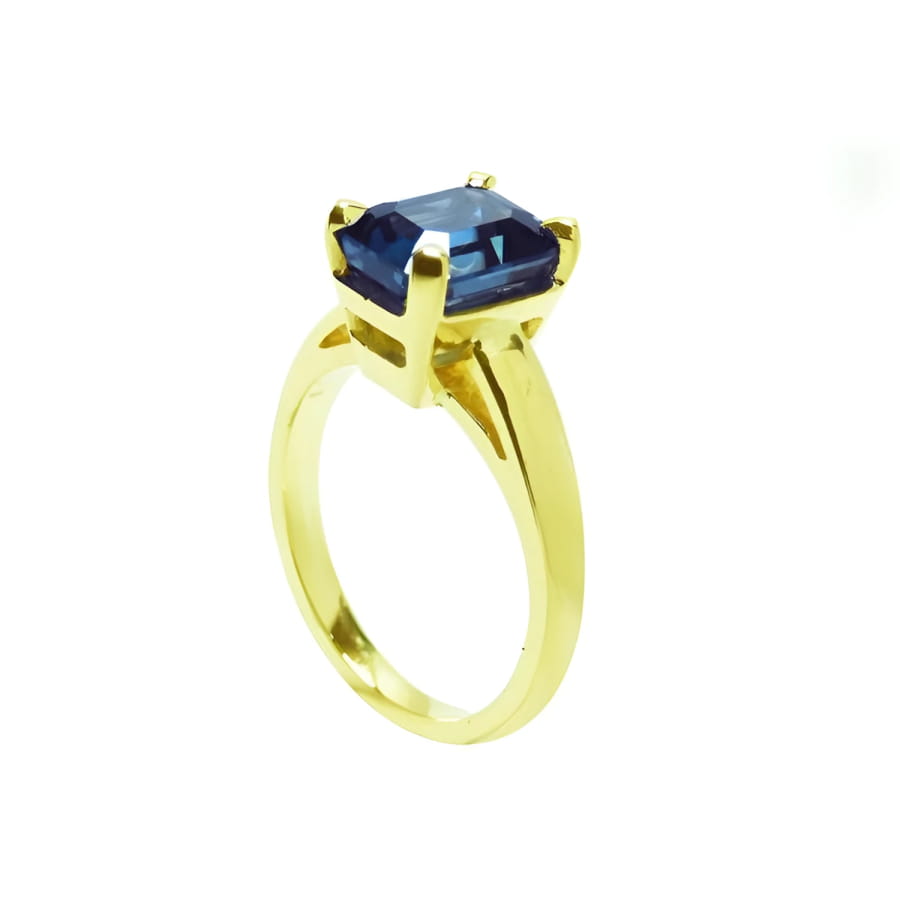 3.13 ct. deep blue emerald-cut sapphire solitaire ring in 14K yellow gold.