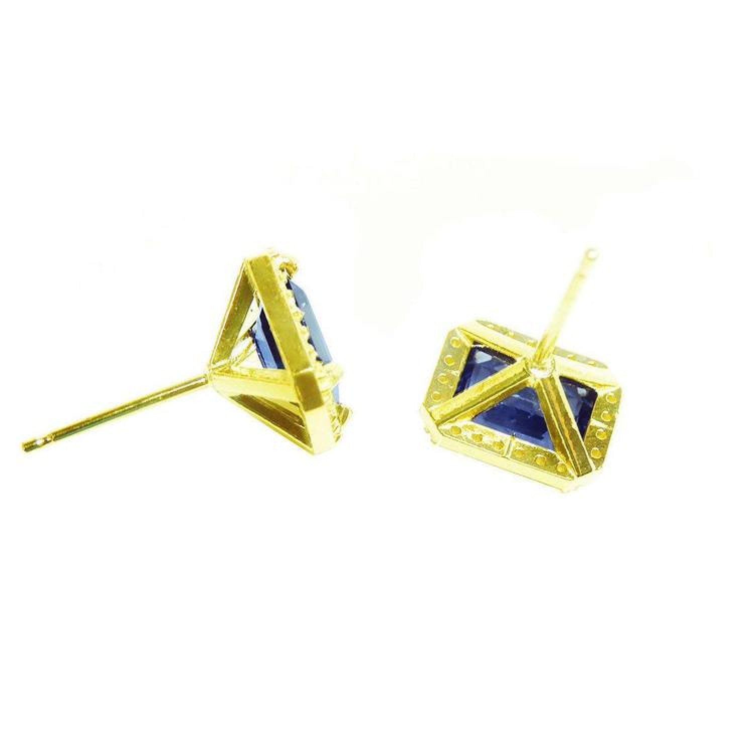 Emerald cut blue sapphire stud earrings with halo diamonds in 14K yellow gold.
