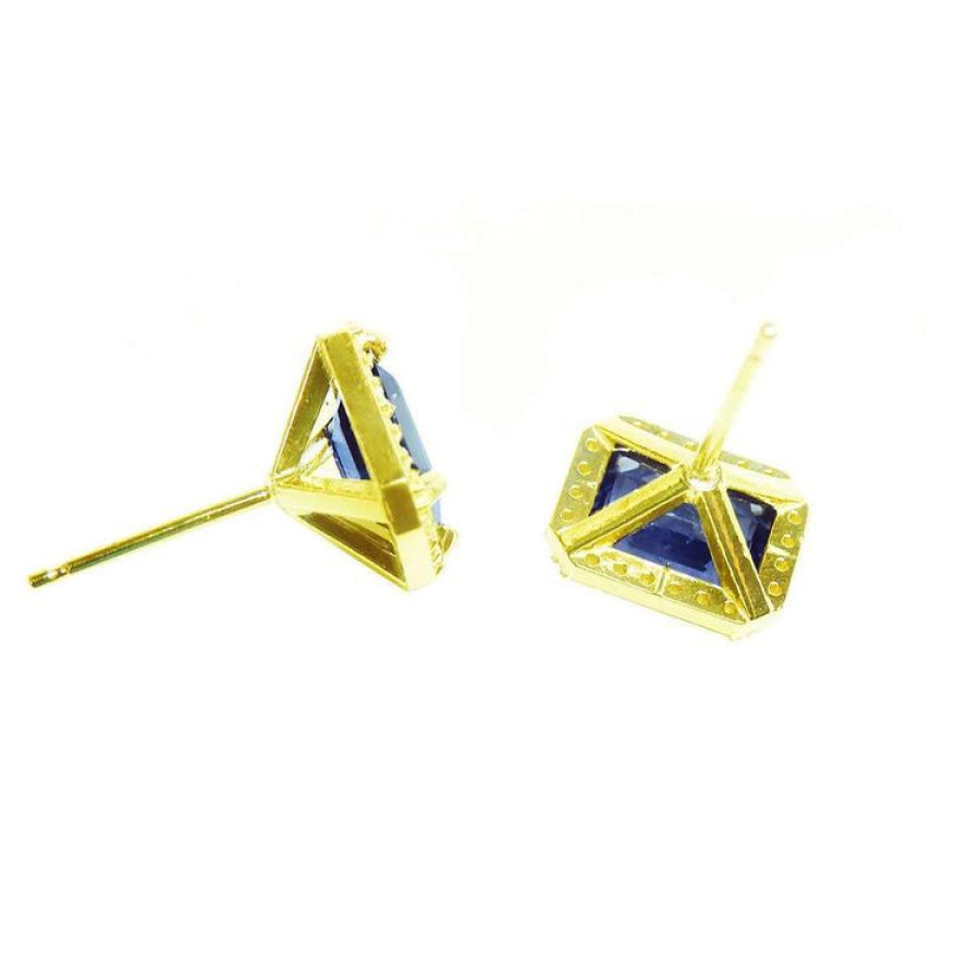 Emerald cut blue sapphire stud earrings with halo diamonds in 14K yellow gold.