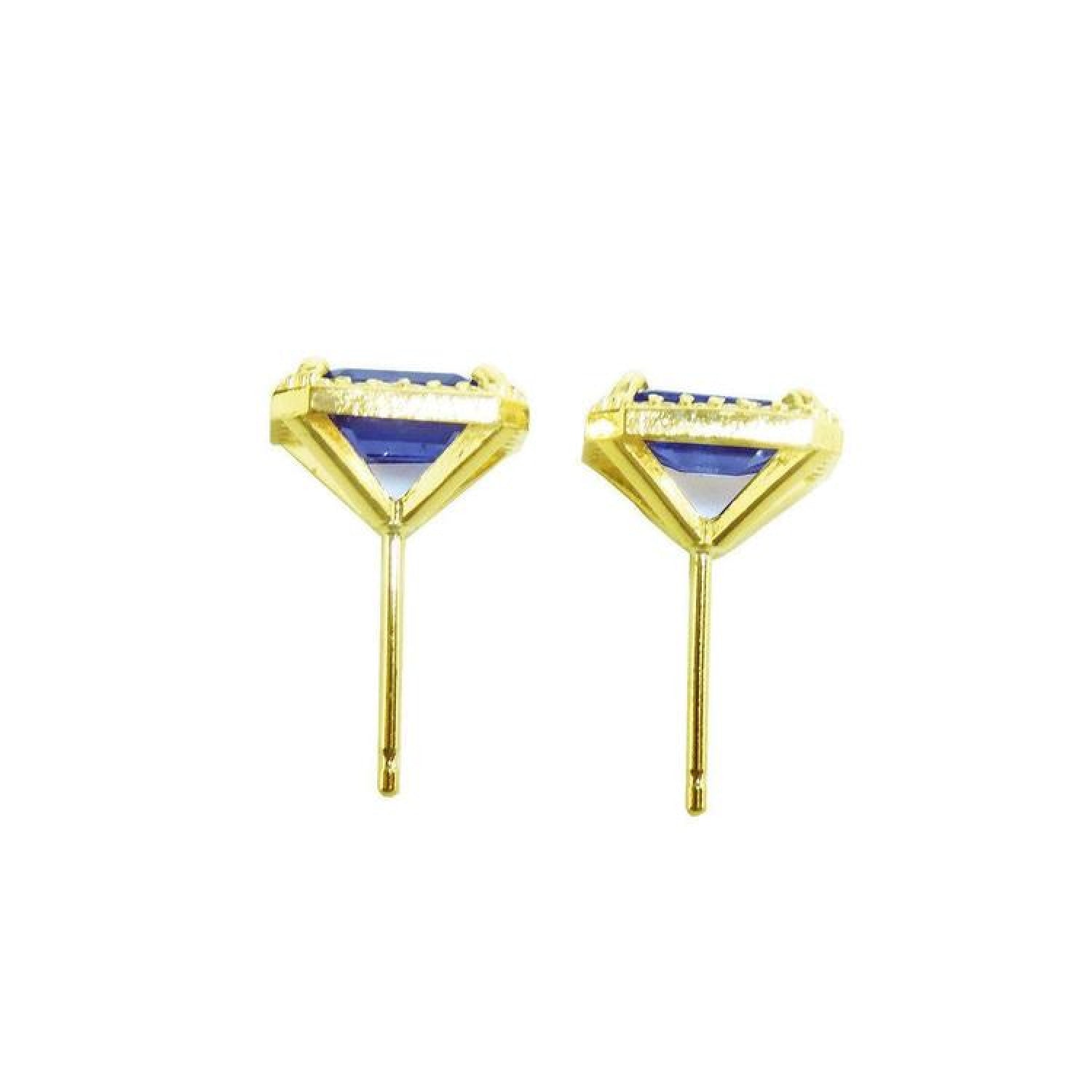 Emerald cut blue sapphire stud earrings with halo diamonds in 14K yellow gold.