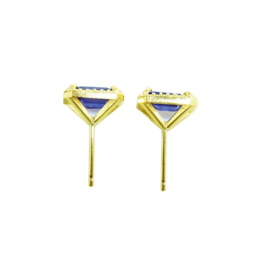 Emerald cut blue sapphire stud earrings with halo diamonds in 14K yellow gold.