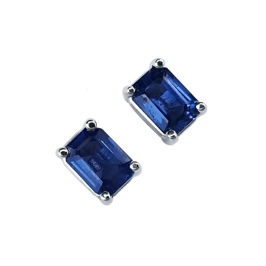 Pair of emerald-cut natural deep blue sapphire solitaire stud earrings in 14K white gold, four-prong setting.