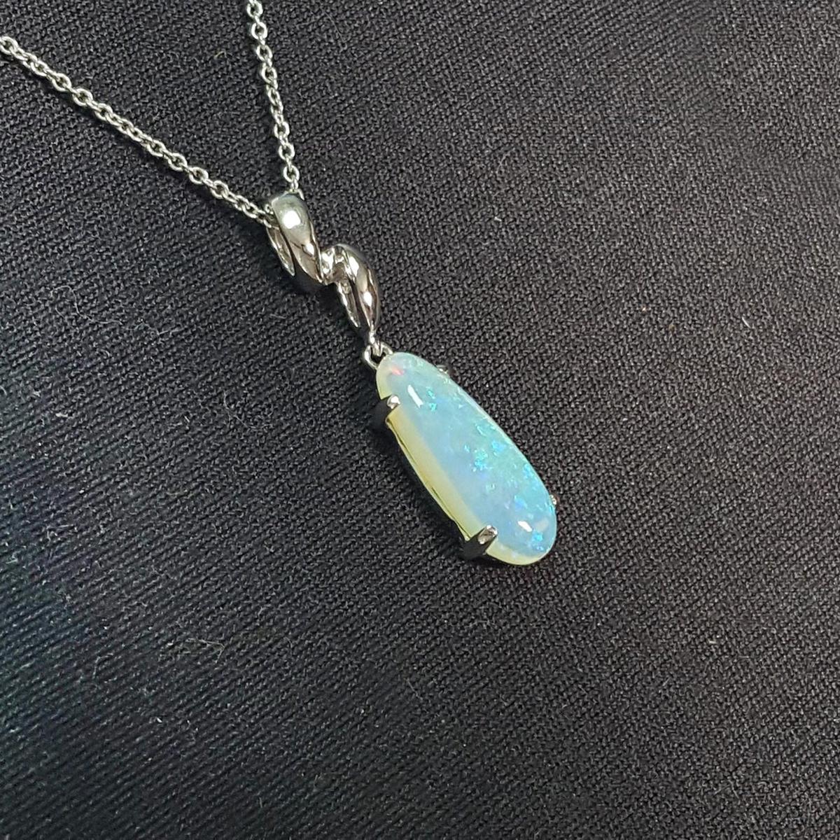 Opal pendant necklace on a black background