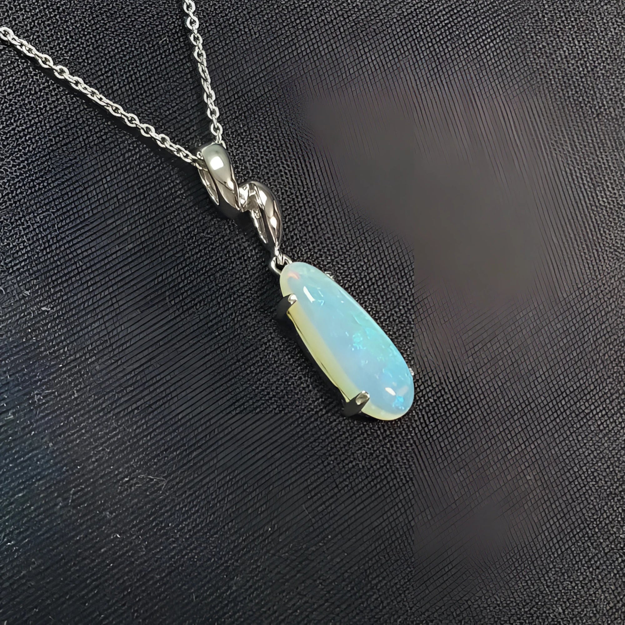1.56 ct bluish-green opal pendant in 14K white gold, elongated pear shape.