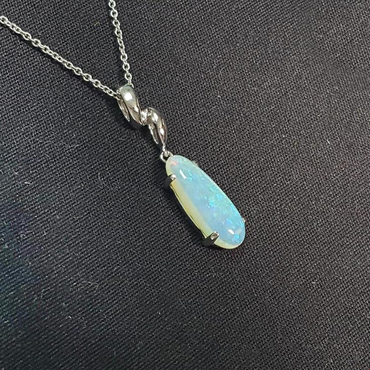 Opal pendant necklace on a black background