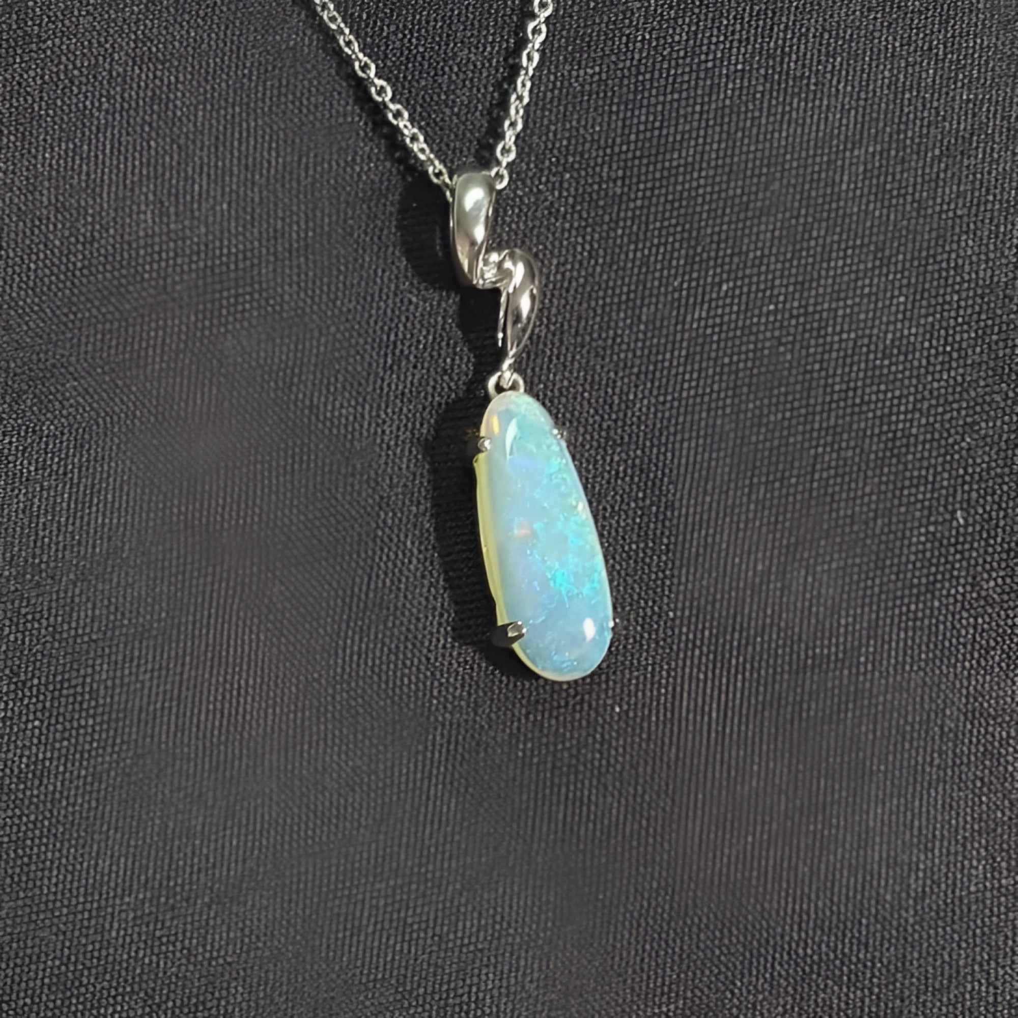 1.56 ct. bluish-green opal pendant in an elongated pear shape, set in 14K white gold on a silver chain.