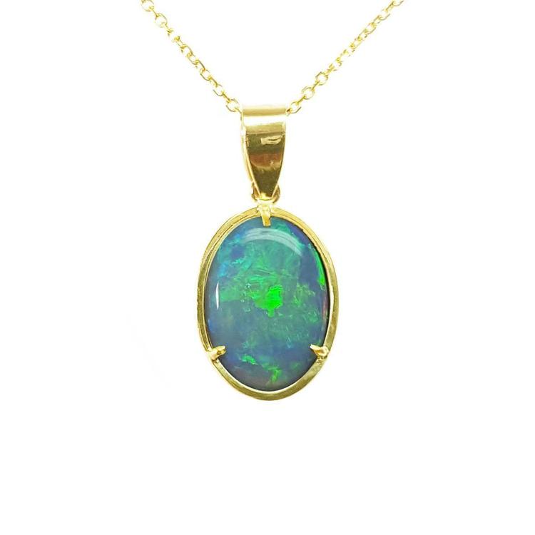 Opal pendant with gold frame on a topside view position.
