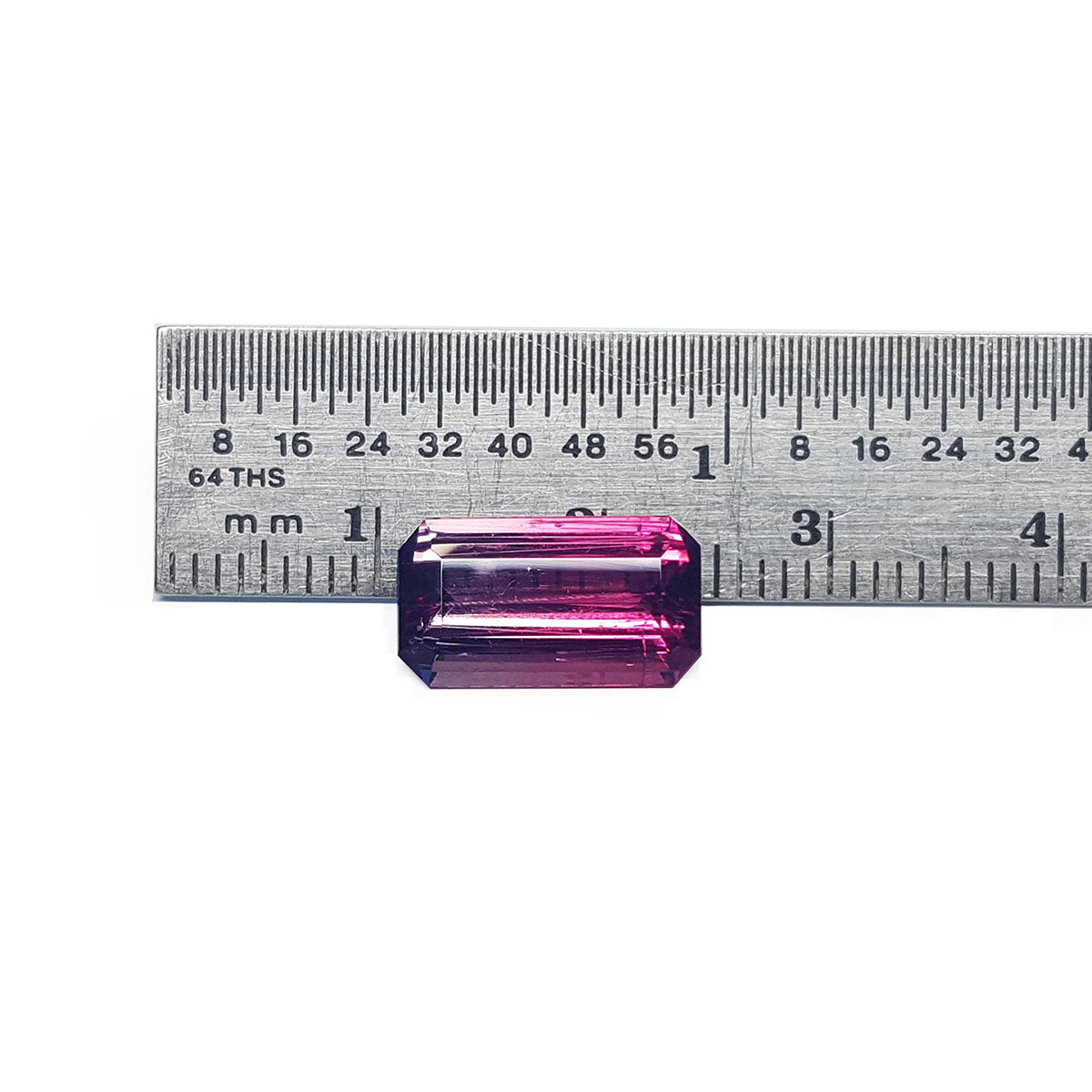 A pink brazilian tourmaline watermelon next to ruler for measure.