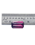 A pink brazilian tourmaline watermelon next to ruler for measure.
