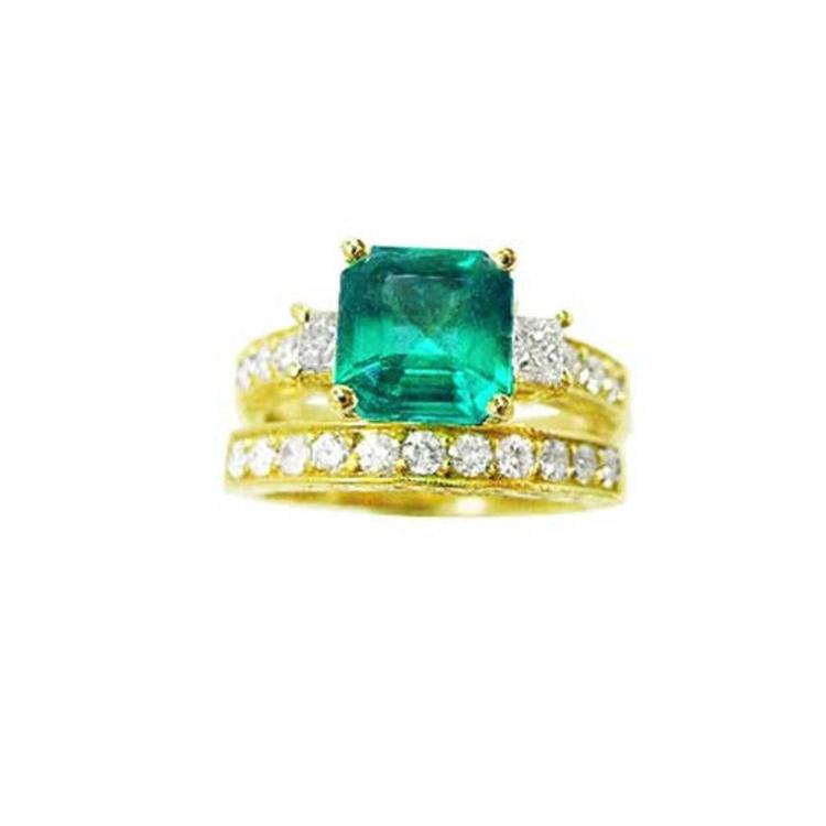 Emerald ring bridal style with accent diamonds and matching band made in 14k yellow gold.
