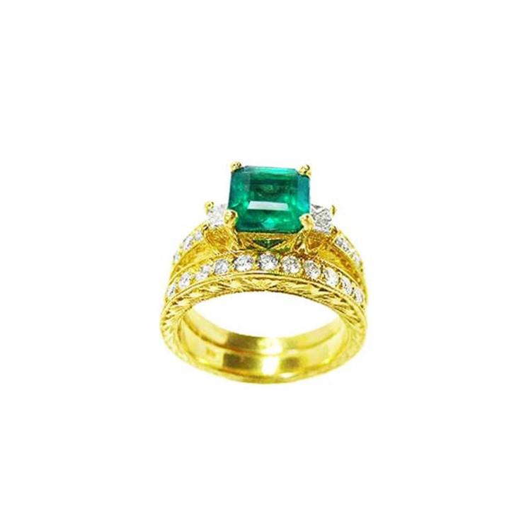 14K gold bridal emerald ring set with a sparkling green emerald and princess-cut side diamonds.