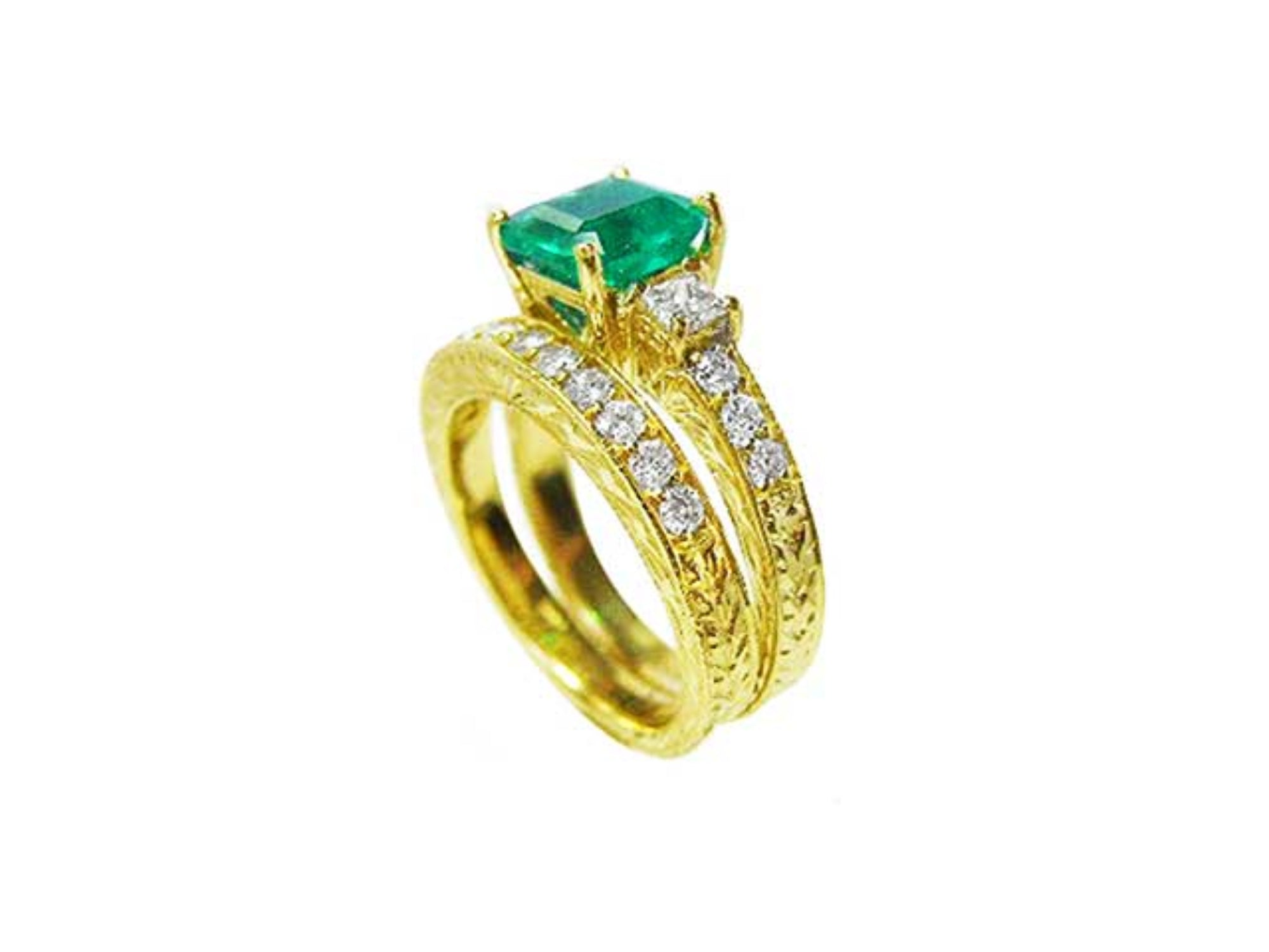 Displaying a bridal wedding band and the matching emerald ring together side profile. 