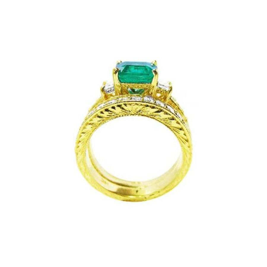14K yellow gold bridal emerald ring set with matching engraved wedding band and princess cut side diamonds.