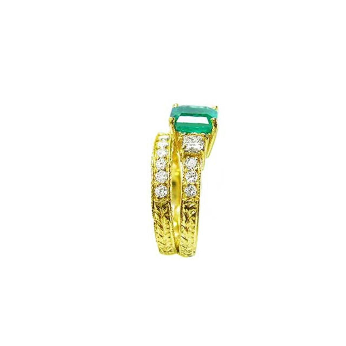 The side view of a bridal emerald ring and matching band, showing the top gemstone and side profiles.
