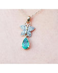 14K gold butterfly pendant with pavé diamonds and a pear-shaped Colombian emerald.