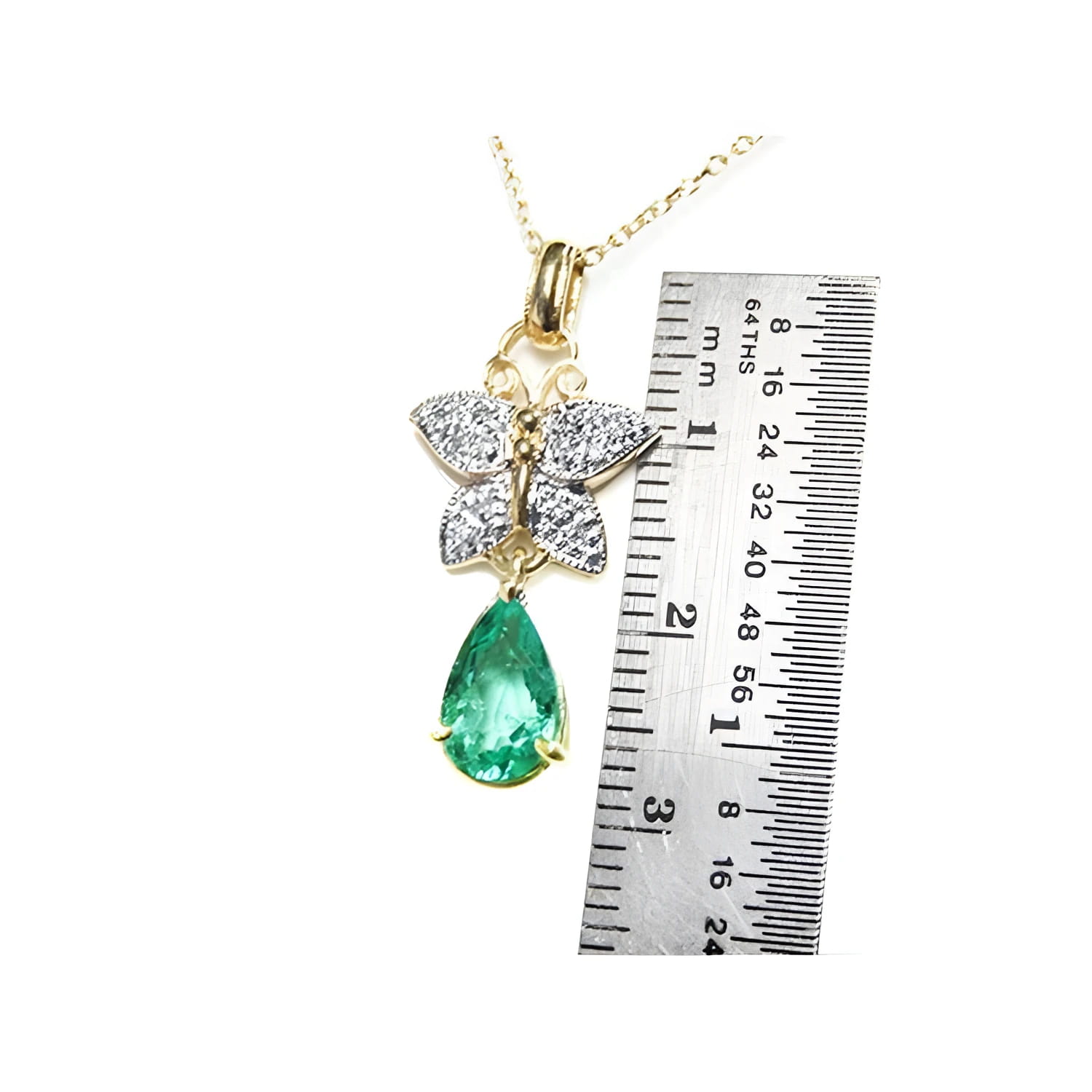 14K gold butterfly pendant with pavé diamonds and a pear-shaped Colombian emerald, shown with ruler.