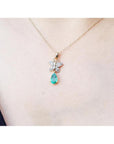 14K gold butterfly pendant with pavé diamonds and a pear-shaped Colombian emerald.