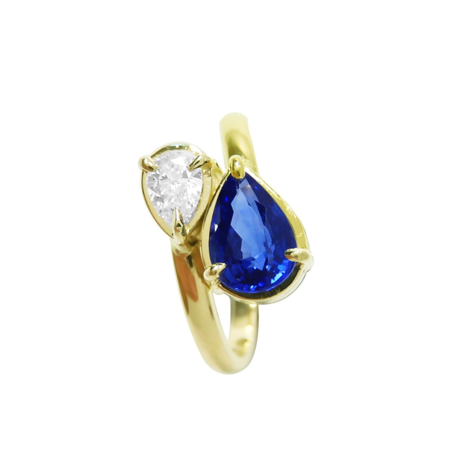 Two-stone "You and Me" blue natural sapphire bypass ring side teardrop diamond on the side, handcrafted in 18k yellow gold.