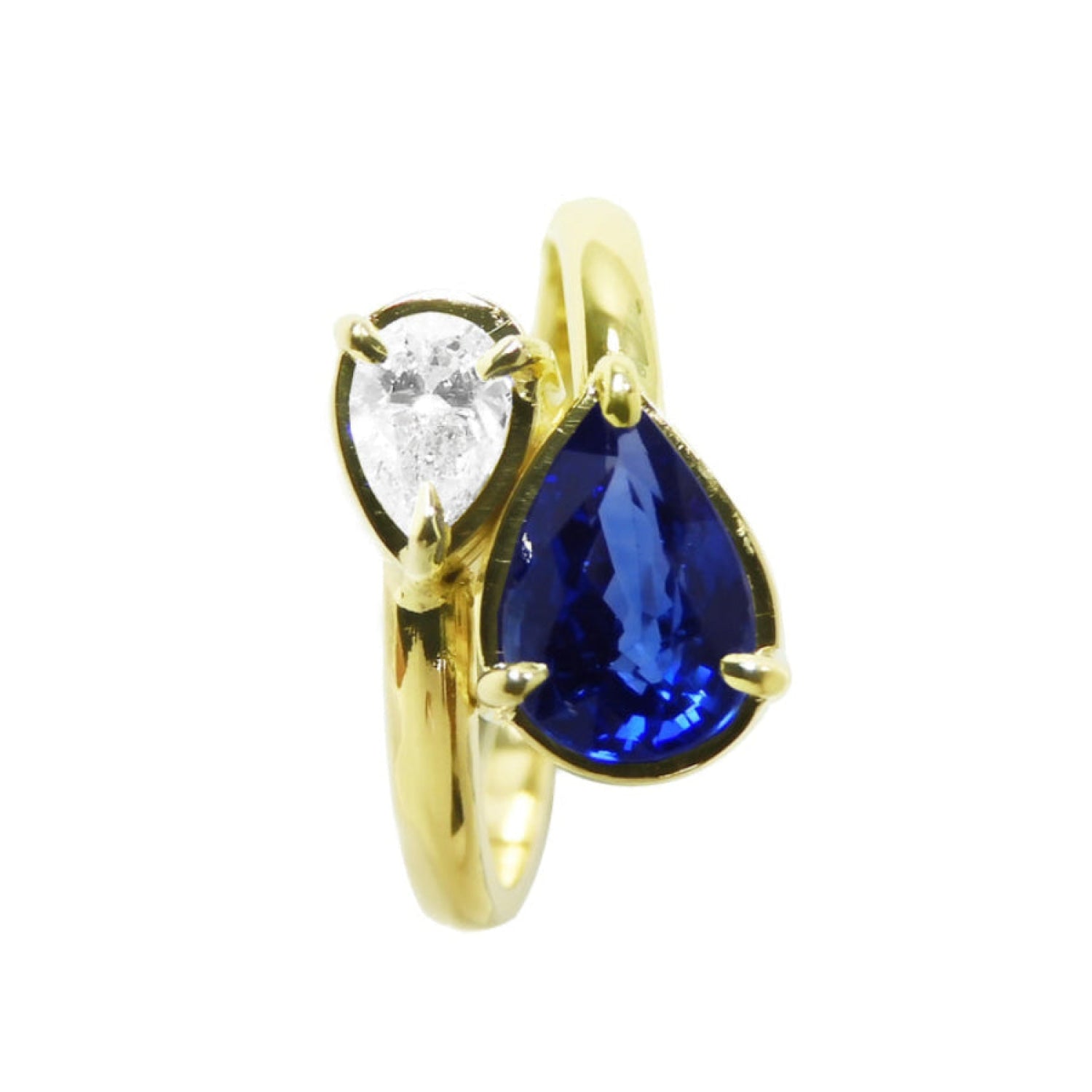 A bypass 18k yellow gold you and me ring toi et moi design featuring a natural pear-cut blue sapphire and a smaller diamond.