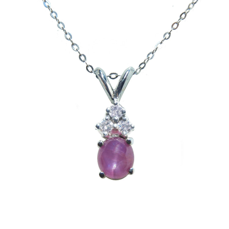 This necklace pendant slider showcases a natural oval pink sapphire cabochon and is crafted in 14k white gold.