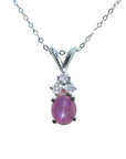 This necklace pendant slider showcases a natural oval pink sapphire cabochon and is crafted in 14k white gold.