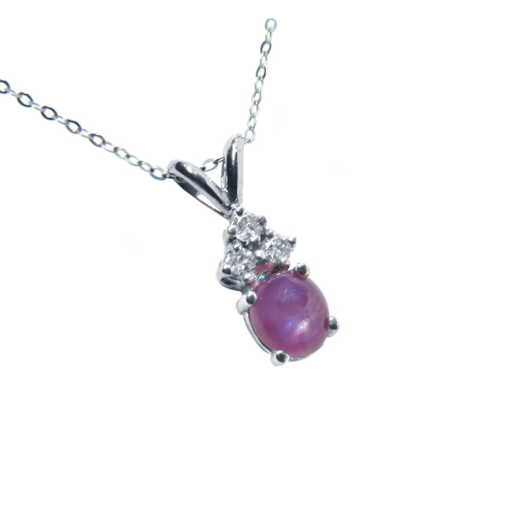 This 14k white gold necklace pendant slider showcases a natural oval pink sapphire cabochon.