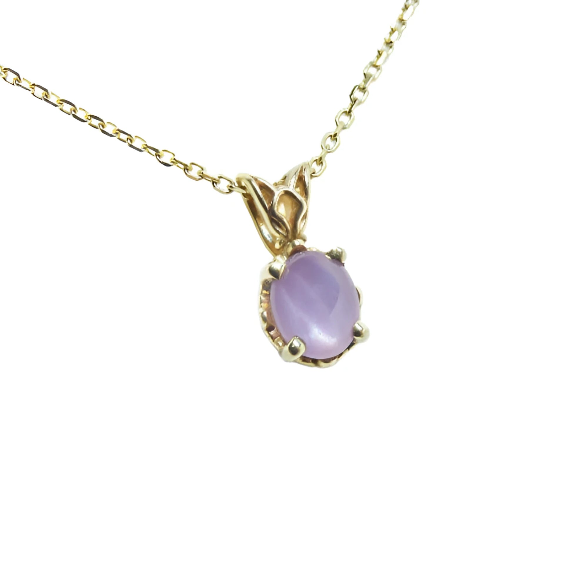 Natural oval-cut cabochon pink sapphire pendant necklace with a medium sparkle hue, set in prongs within a 14k yellow gold scroll design.