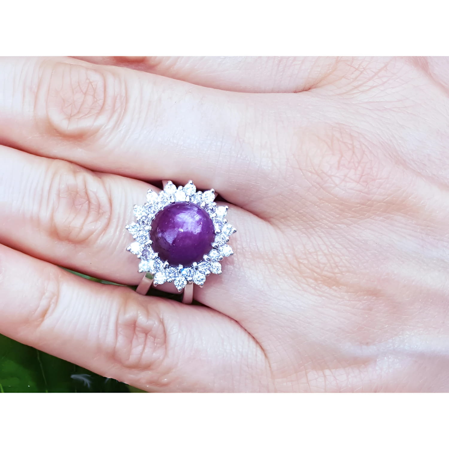 Red purple cabochon star ruby women's ring gemstone on a hand