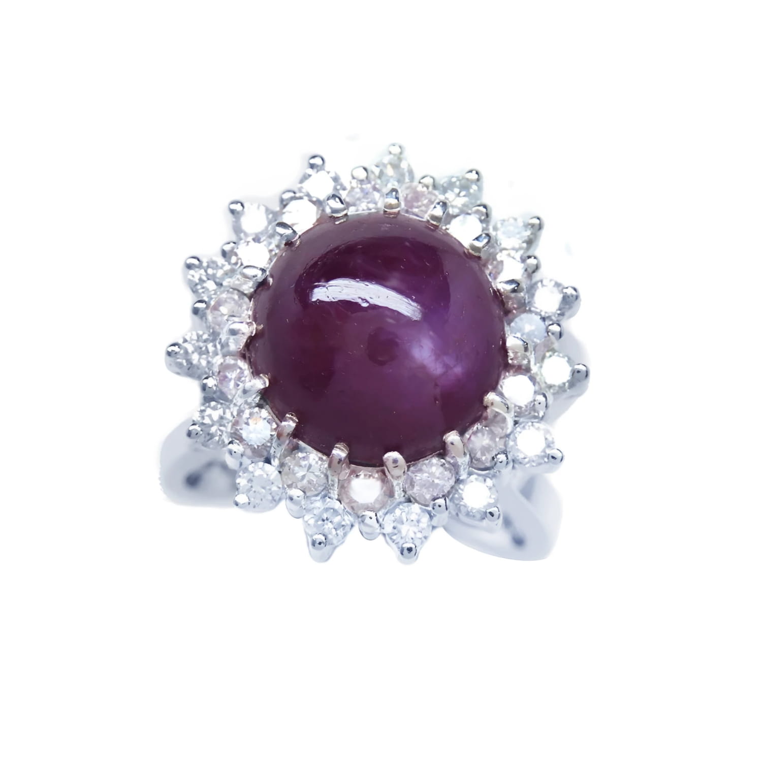 Women's 18K white gold ring with a purple cabochon star ruby and double halo diamonds.