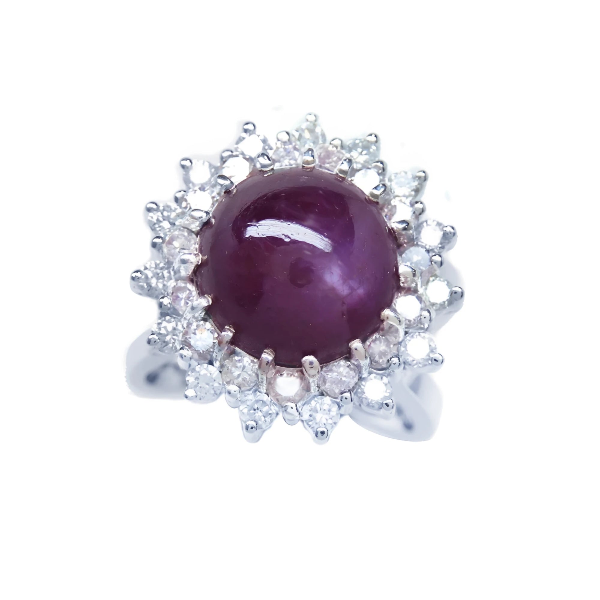 Women's 18K white gold ring with a purple cabochon star ruby and double halo diamonds.