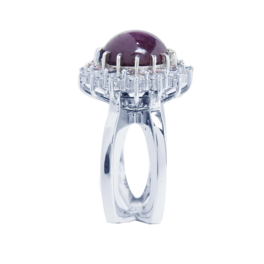Red purple cabochon star ruby women's ring side top view in a double halo natural diamonds