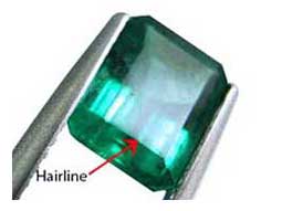 spotting a concealed hairline fracture in surface of the emerald gemstone 