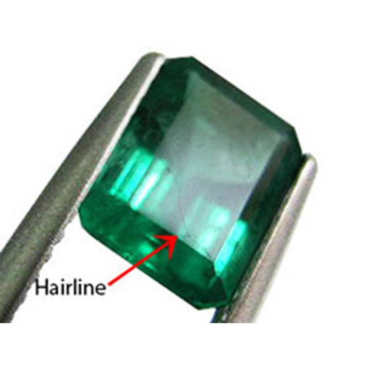 spotting a concealed hairline fracture in surface of the enhanced emerald gemstone.