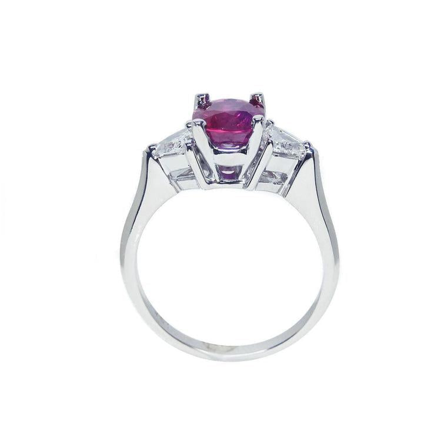 Women's 14k white gold ring with a deep red ruby and trillion side diamonds.