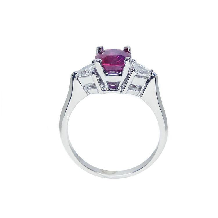 Women's 14k white gold ring with a deep red ruby and trillion side diamonds.