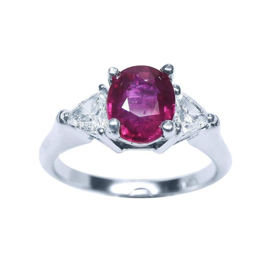 Women's 14k white gold ring with a deep red oval ruby and two trillion side diamonds.