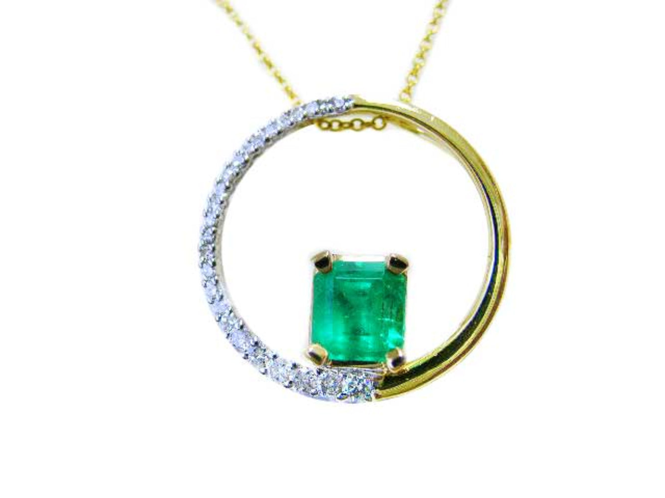 A yellow gold circle of life pendant necklace with a center square natural colombian emerald topside displayed.
