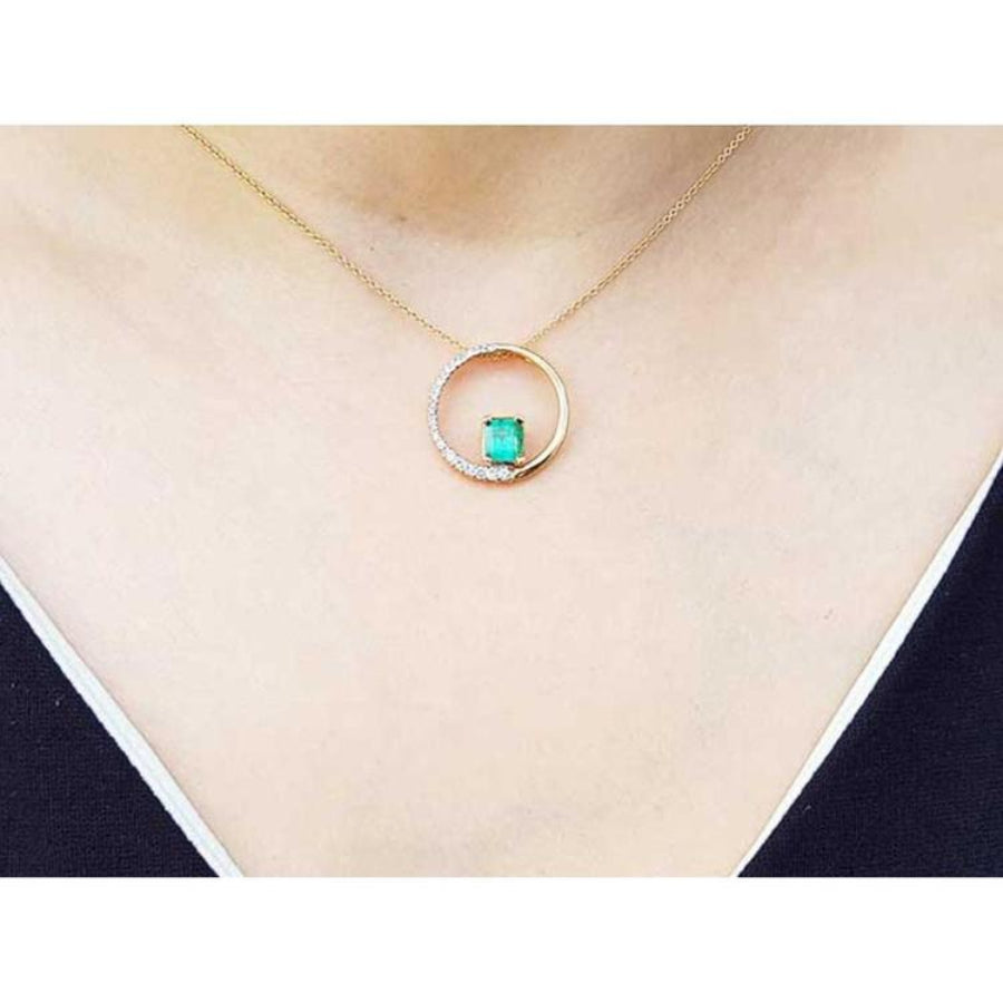 14K gold "Circle of Life" emerald pendant with natural diamonds on a delicate chain.