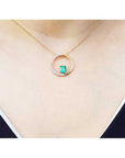 14K gold "Circle of Life" emerald pendant with natural diamonds on a delicate chain.